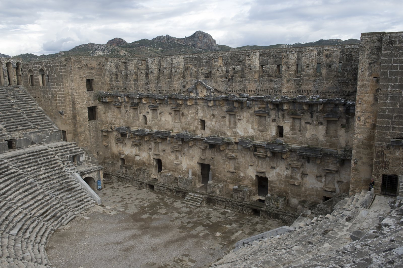 Stage building and seating of the Roman theatre at Aspendos under a cloudy sky