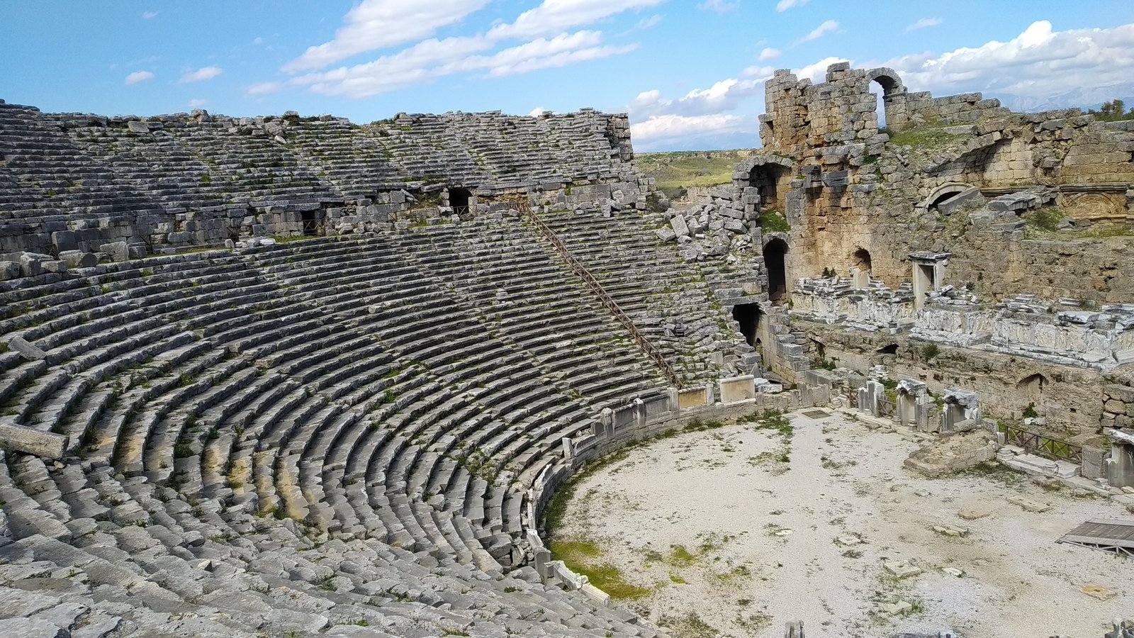 Stone seating of the Roman theatre at Perge under a blue sky